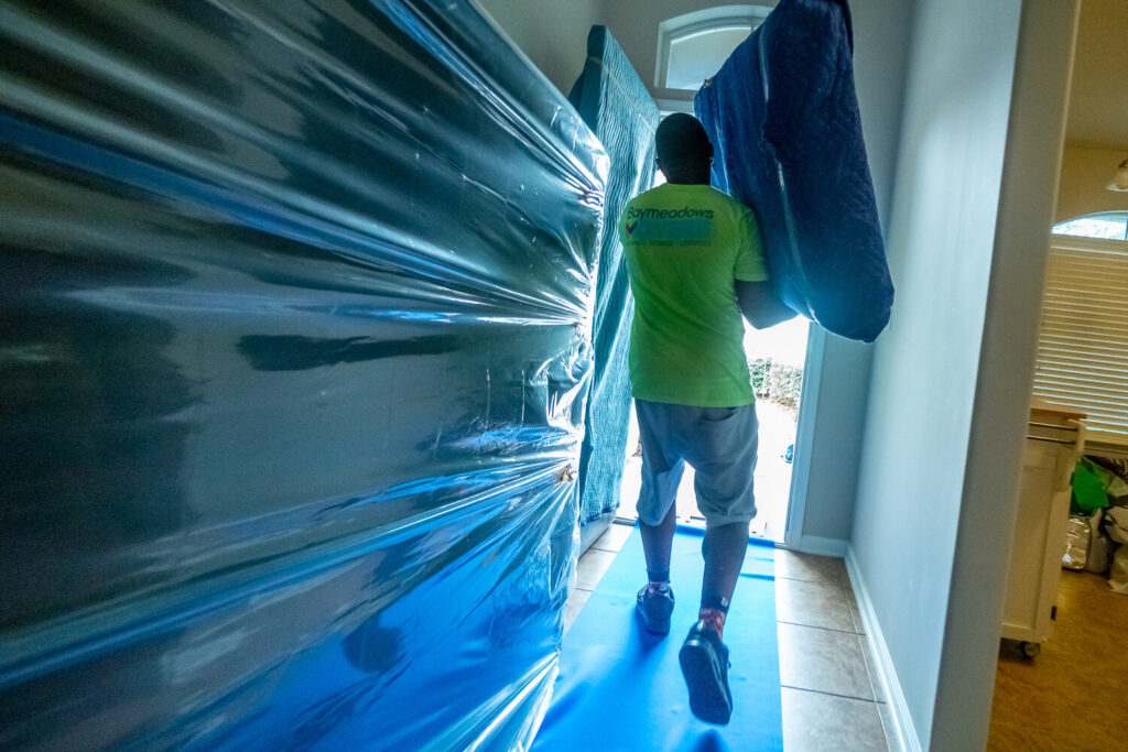 We pad the front door with our quilted blankets. This helps keep your stuff intact along with those pesky door dings.